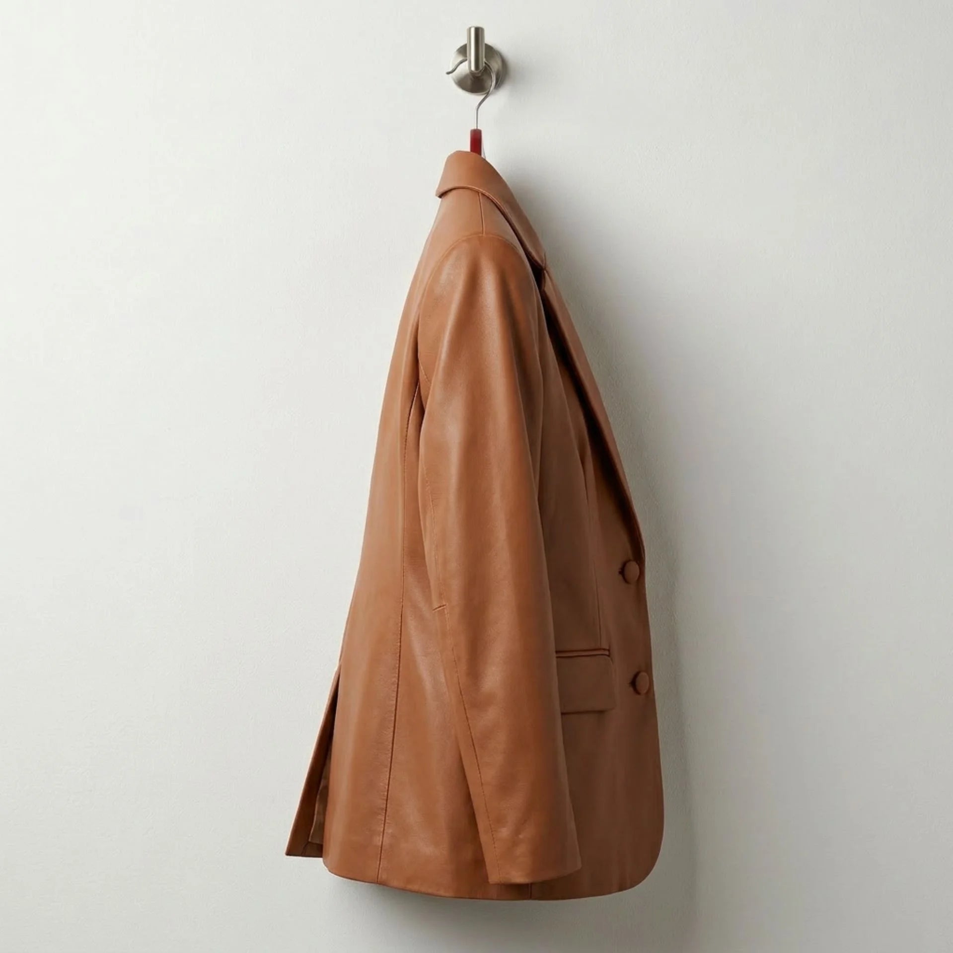 Side profile of tailored women’s brown leather blazer jacket