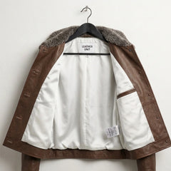 Interior white lining and inside pocket of women’s dark brown leather jacket