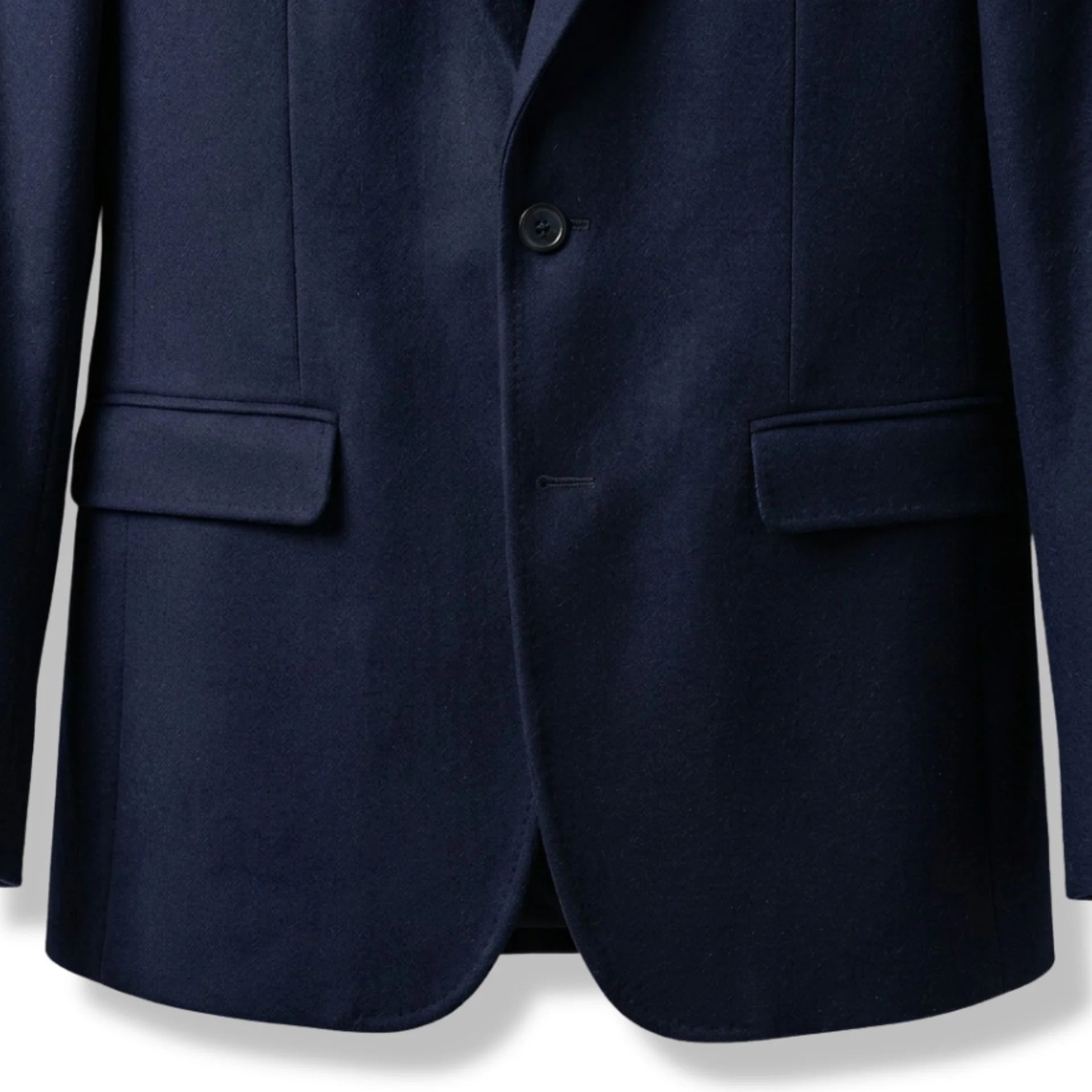 Front flap pockets and single button closure on women’s navy wool blazer