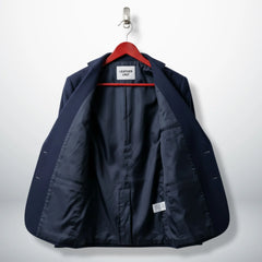 Inside lining of women’s navy blue wool blazer showing inner pockets