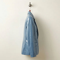Side profile of women’s sapphire blue tailored leather blazer
