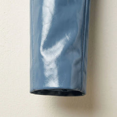 Sleeve and cuff detail on women’s glossy sapphire blue leather blazer