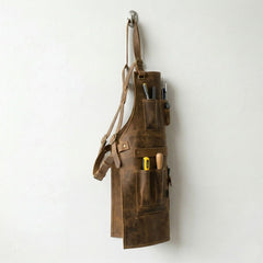 Side profile of brown cowhide woodworking apron loaded with tools