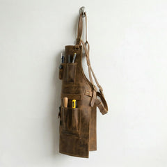 Opposite side view of leather work apron with pockets and straps