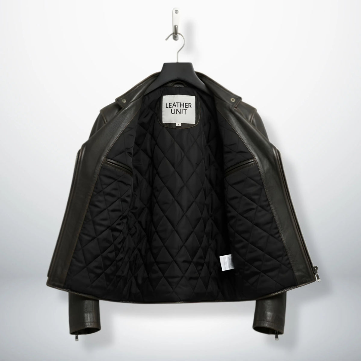 interior of men's leather biker jacket showing black quilted lining.
