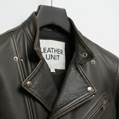 close up of lapel collar and snaps on men's asymmetrical leather biker jacket.