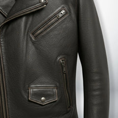 detail of chest zip pocket and flap pocket on men's dark brown leather jacket.