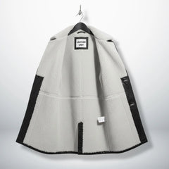 Interior of men's Bane leather coat showing full white shearling lining.