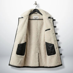 Inside cream sherpa lining of men’s black Bane leather coat
