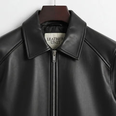 close up collar and zipper on mens black bomber leather jacket leather unit label.