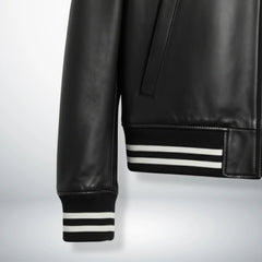 close up striped ribbed cuff and hem on black leather bomber jacket.