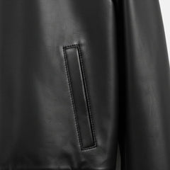 close up welt hand pocket on mens black genuine leather bomber jacket.