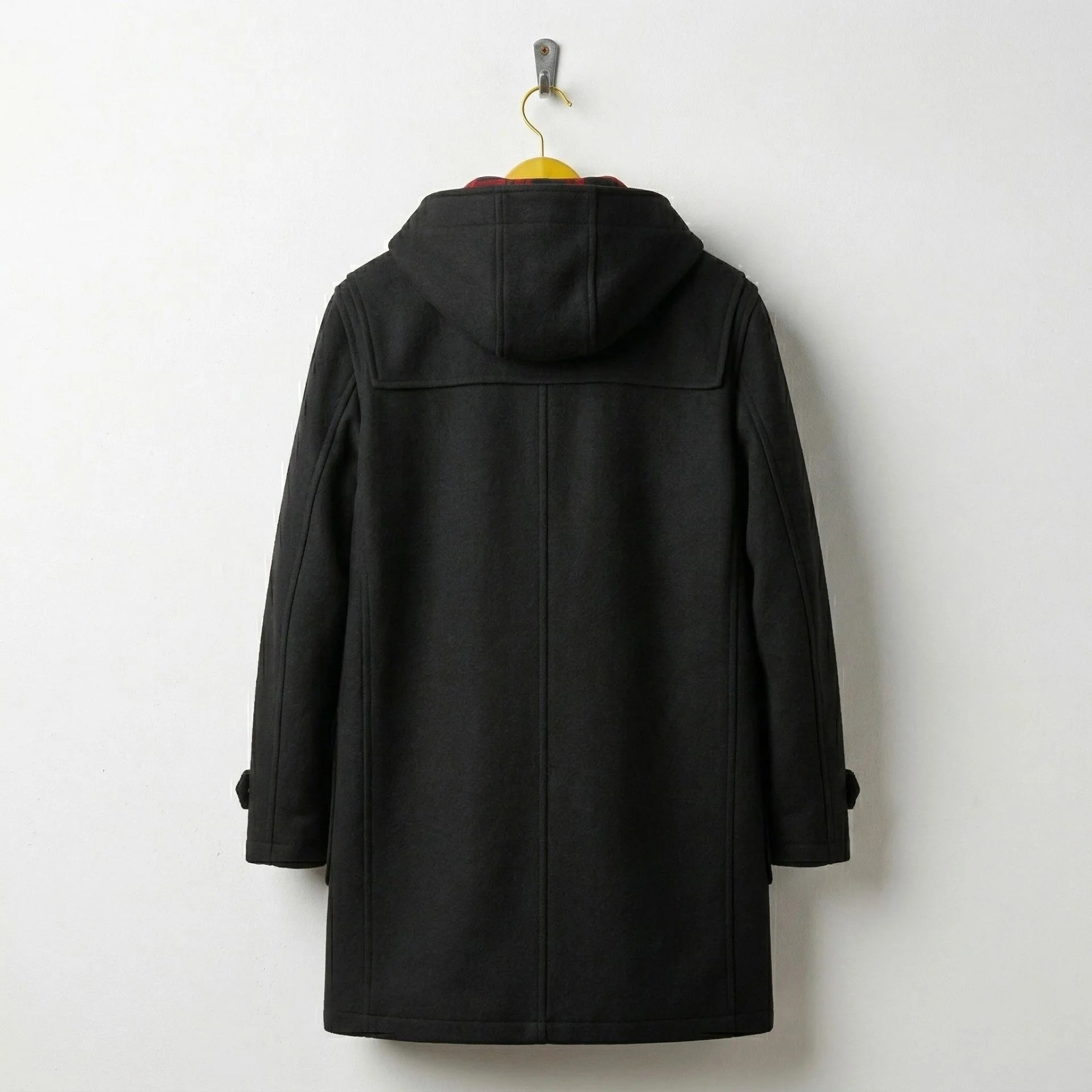 Back view of men's black wool duffle coat with hood.