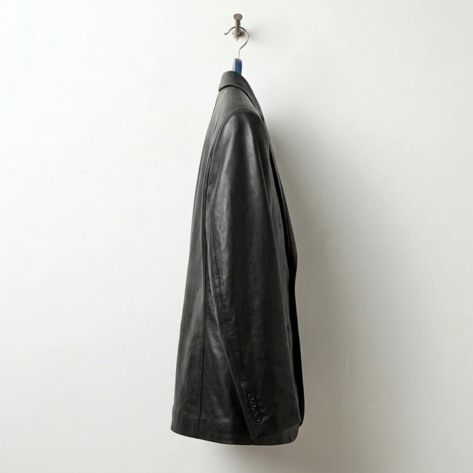 Side profile of men’s black leather sport coat