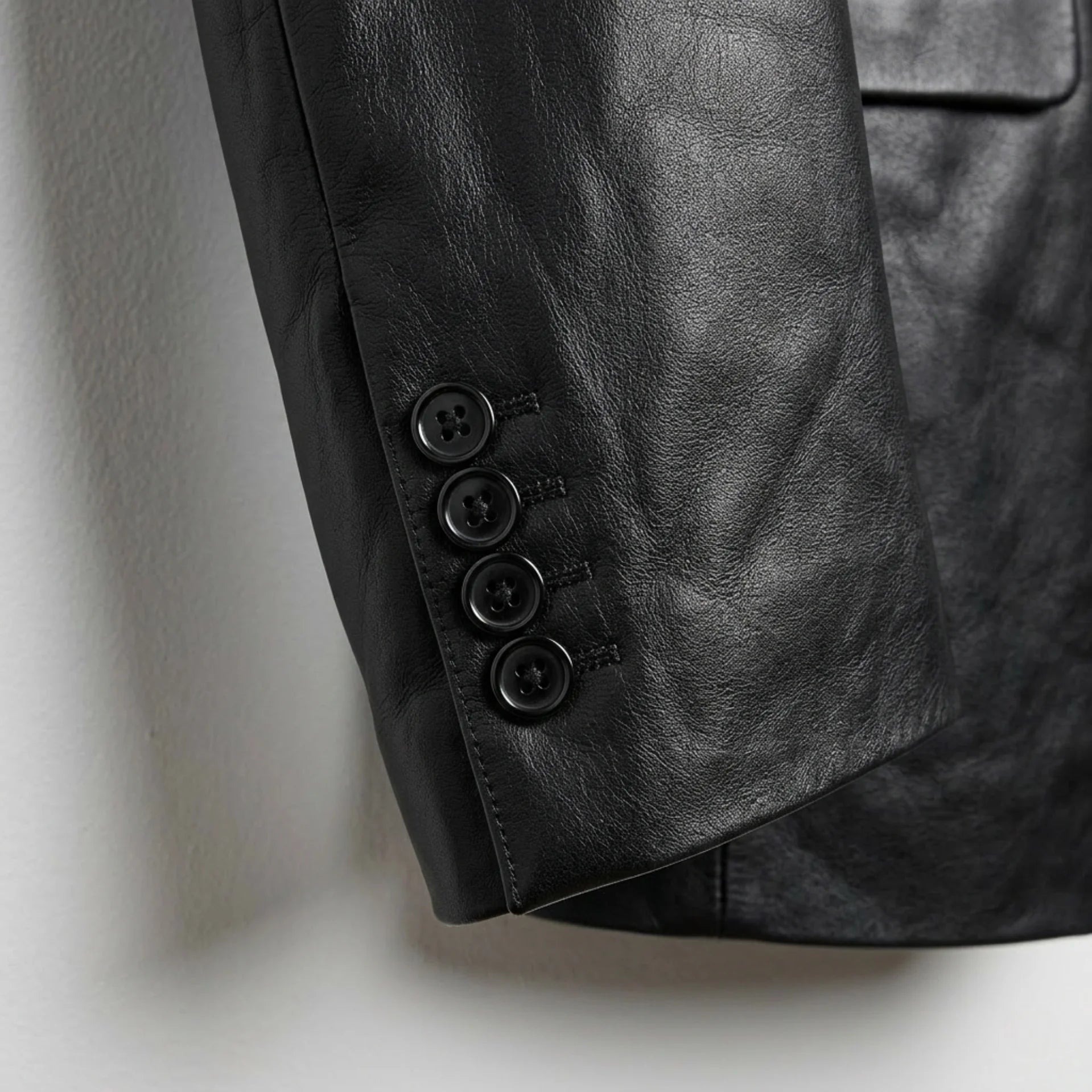 Sleeve cuff buttons on men’s black lambskin leather blazer