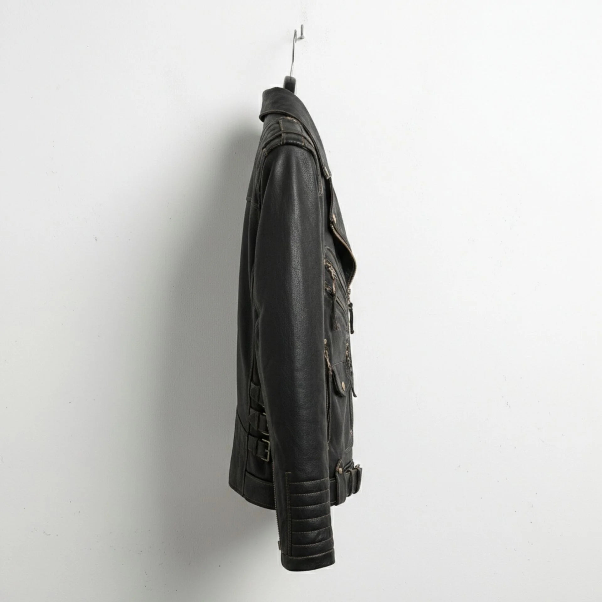 side profile of men's black leather biker jacket with sleeve pocket and buckles.