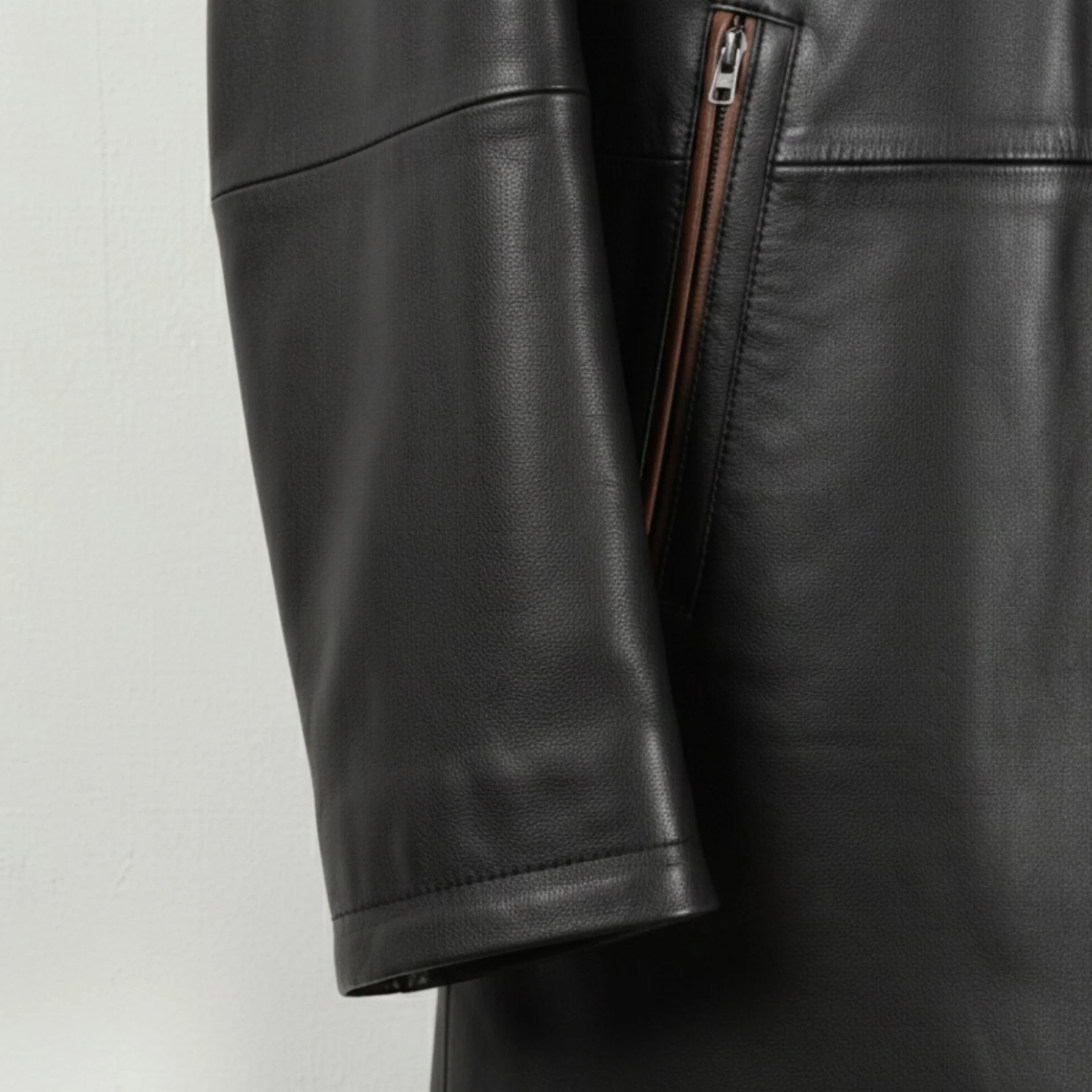 Sleeve and cuff detail on men’s smooth black leather car coat