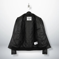 inside view of men's black leather jacket showing quilted lining and inner pocket.