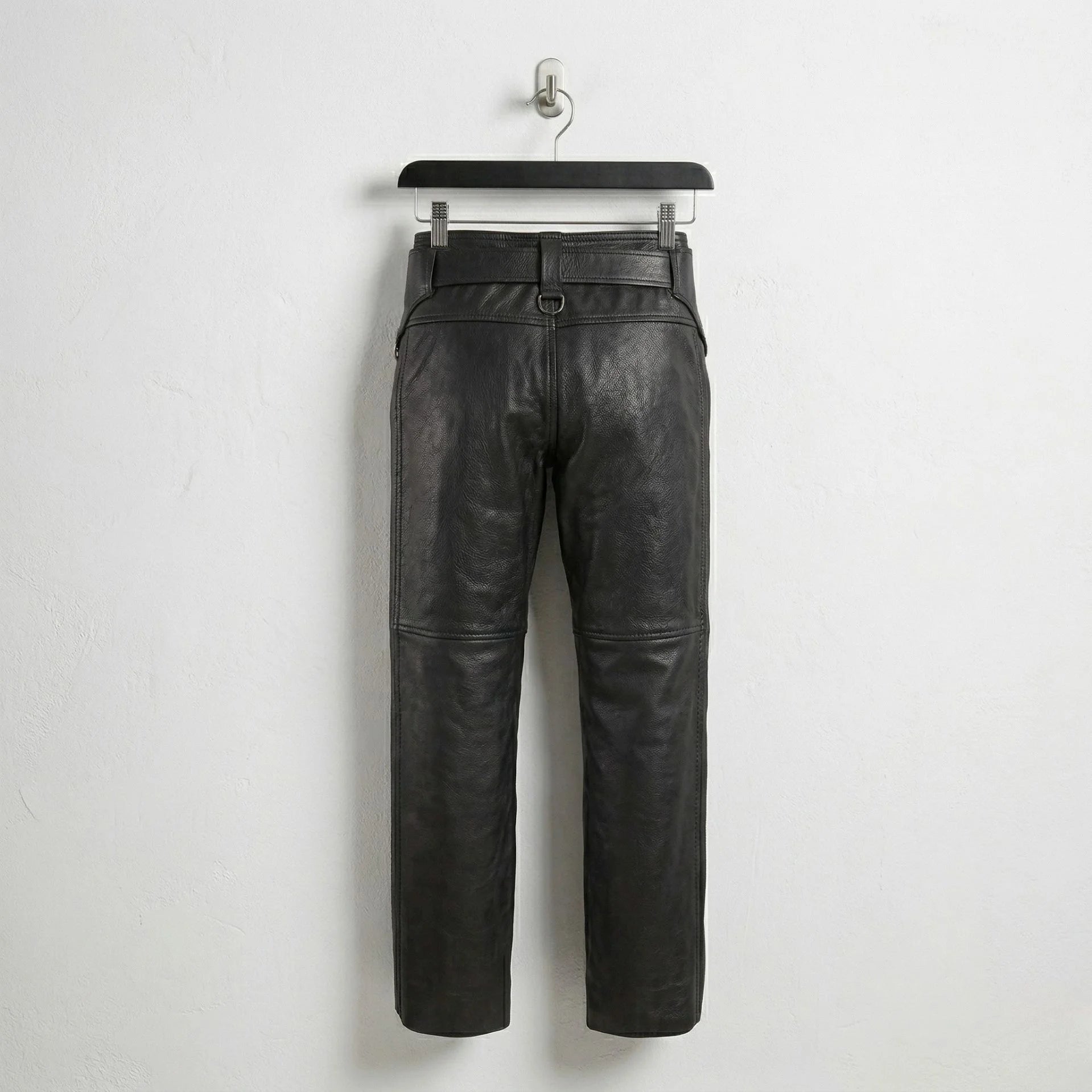 Back view of men's black leather chaps showing straight-leg design