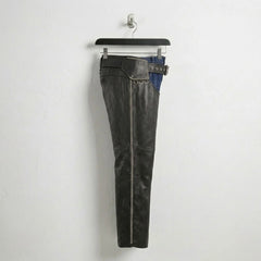 Side profile of men's black leather chaps with full-length zipper and studs.