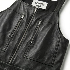 Close-up of bib and twin zip chest pockets on men's black leather overalls