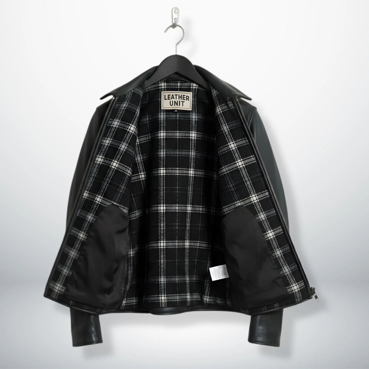 interior of men's black leather rider jacket showing black and white plaid lining.