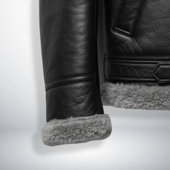 close up shearling cuff and hem on mens black aviator leather jacket.
