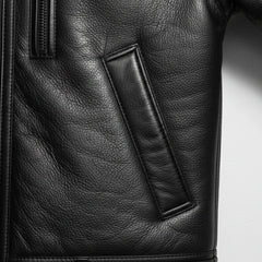 close up welt hand pocket on mens black shearling leather jacket.