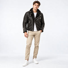 Front model view of obsidian black leather moto jacket with asymmetric zip, fur lapels and waist buckles