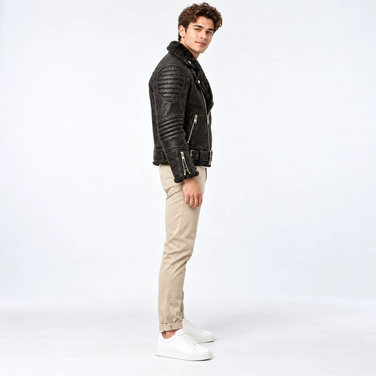Side profile of black sheepskin moto jacket showing padded shoulder and ribbed sleeve quilting