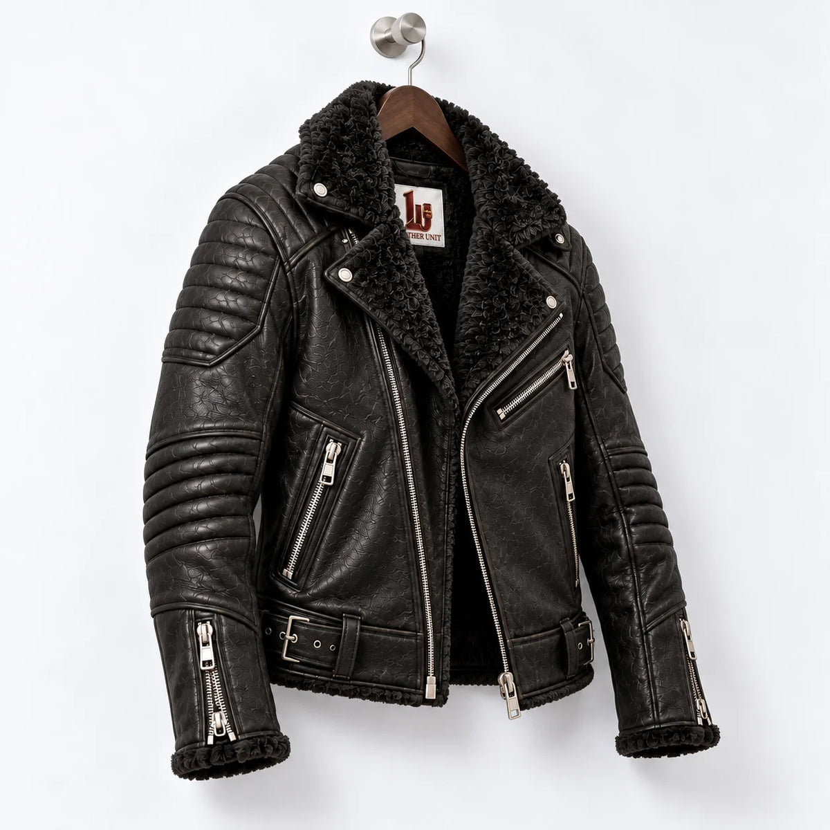 Three-quarter view of obsidian black leather biker jacket with faux fur interior and quilted motorcycle panels