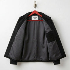 Interior of men's black suede fringe jacket showing grey lining