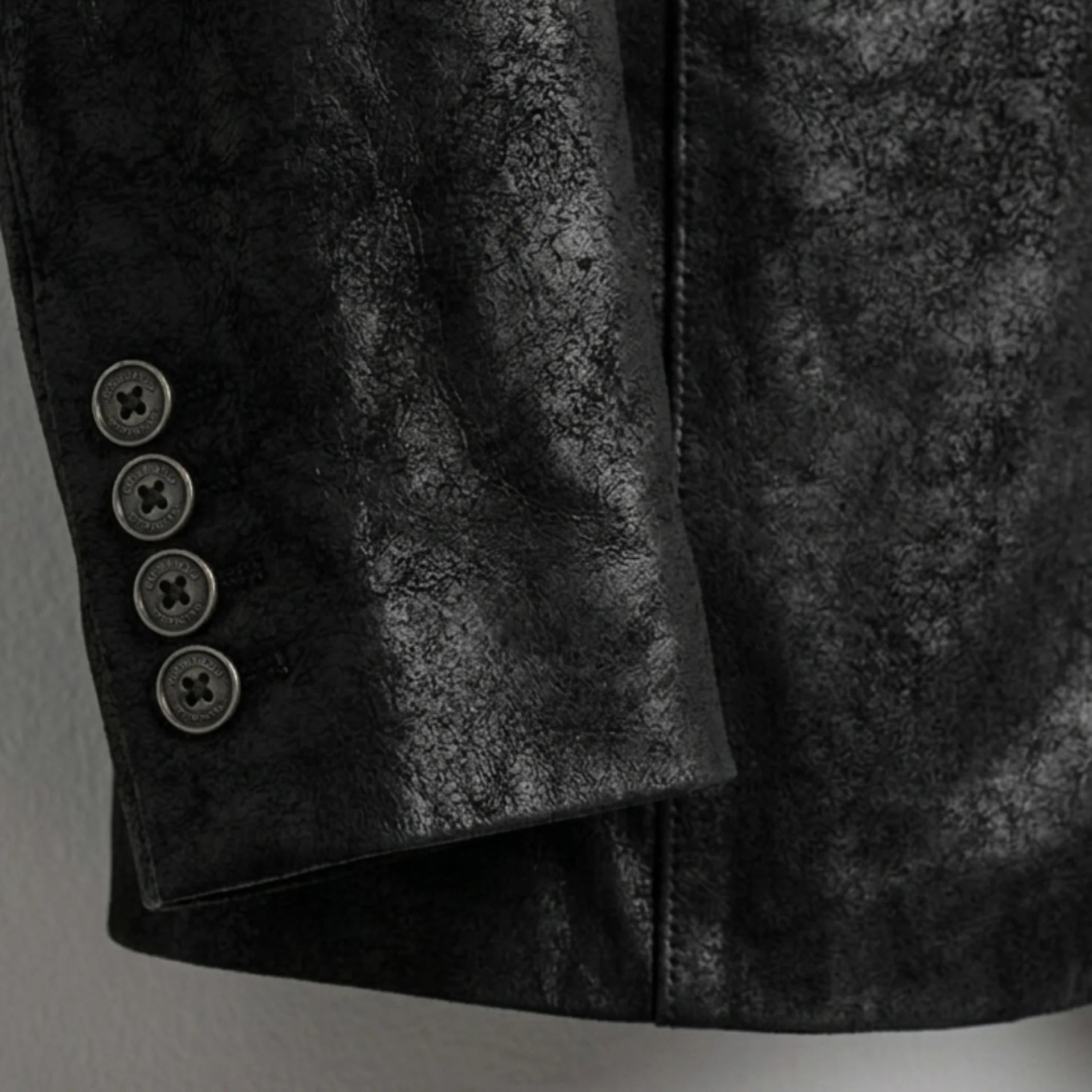 Sleeve cuff buttons on men’s black leather blazer jacket