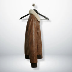 side angle men's brown leather bomber jacket showing pockets.