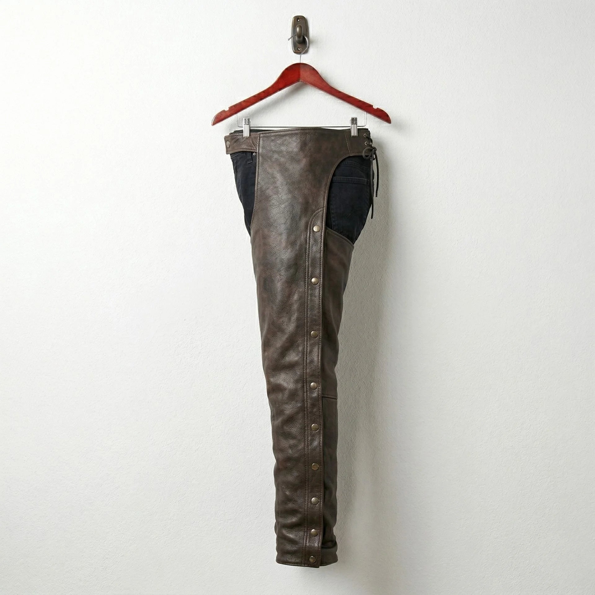Opposite side view of distressed brown motorcycle chaps with snaps