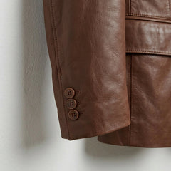 Sleeve cuff button detail on men’s brown leather outer shell blazer
