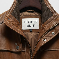 Close up of stand collar and Leather Unit label on brown leather coat