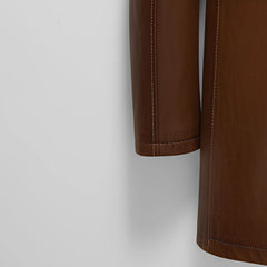 Sleeve hem and stitching detail on men’s brown leather winter coat