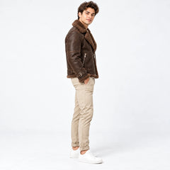 Side profile of men’s brown leather aviator jacket showing faux fur collar, zip pocket and buckle cuff