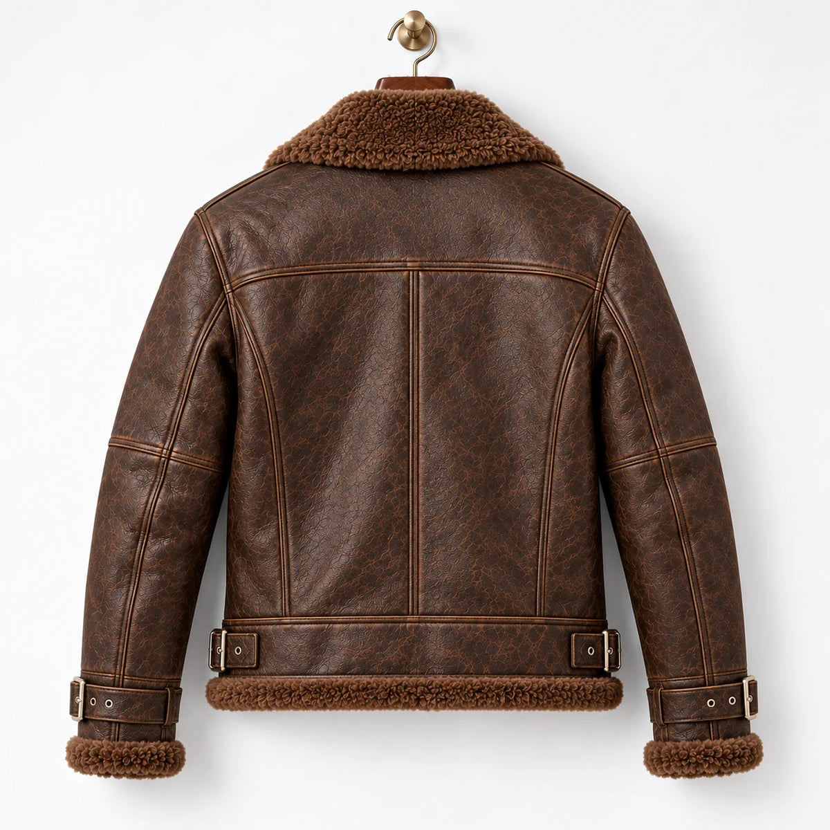 Rear hanger view of brown leather aviator jacket showing shoulder yoke, vertical seams and waist buckle tabs