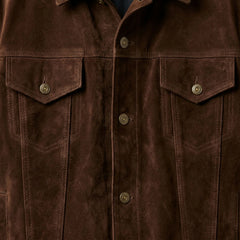 Close up of front buttons and chest pockets on men's brown suede trucker jacket.