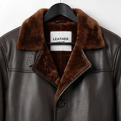 Close up of fur collar and Leather Unit label on dark brown shearling coat