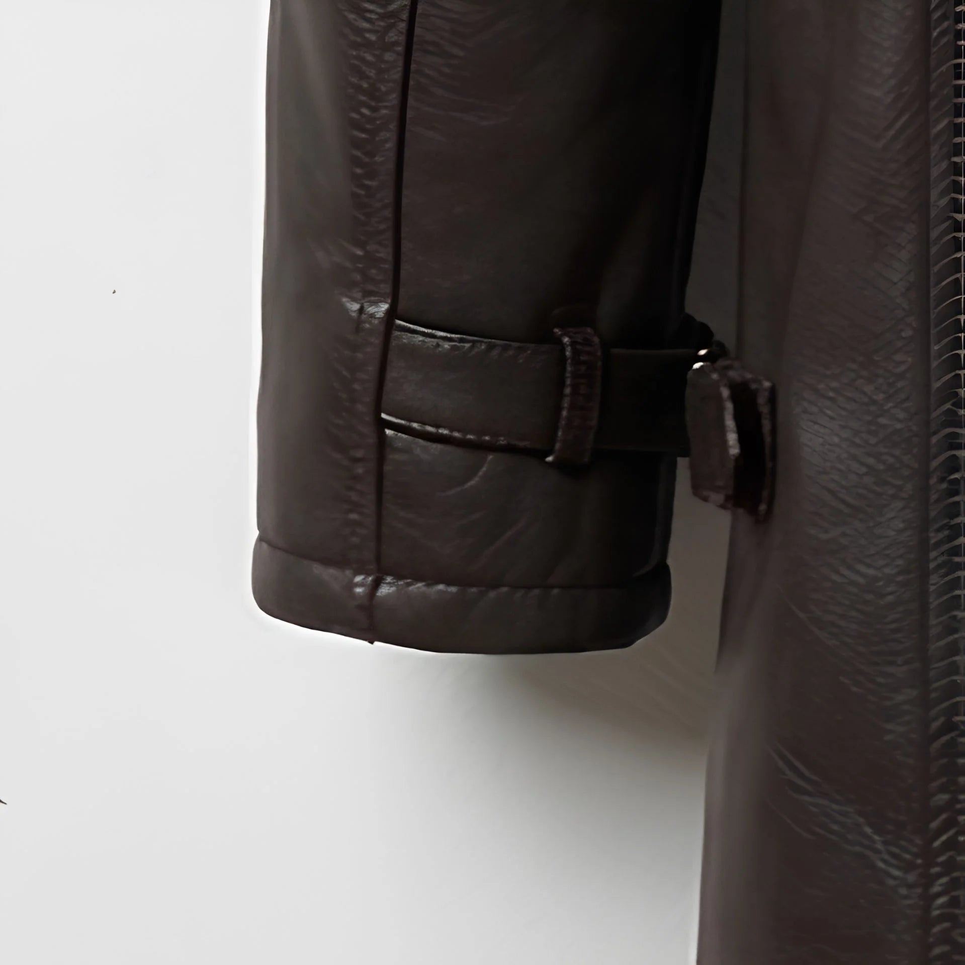 Sleeve strap and cuff detail on men’s dark brown shearling leather coat
