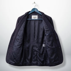 Inside lining of men’s purple suede leather blazer showing interior pockets