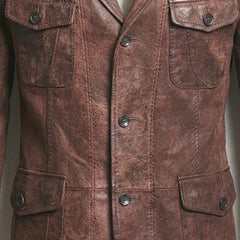 Front buttons and flap pocket close up on men’s distressed brown leather blazer