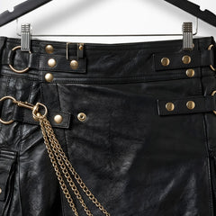 Close-up of waistband straps, buckles and gold hardware on black leather kilt