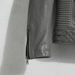 sleeve and cuff zipper close up on men's grey leather motorcycle jacket.