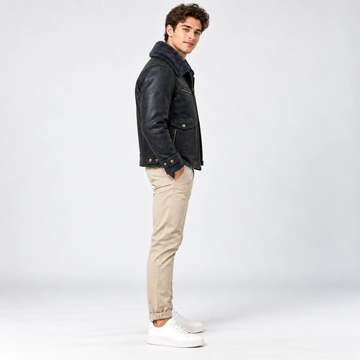 Side profile of men’s navy leather flight jacket showing faux fur collar, patch pocket and adjustable cuff
