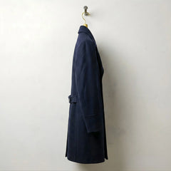 Side profile of men's navy long wool overcoat with tailored fit.