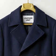 Close up of lapel collar and Leather Unit label on navy wool coat.
